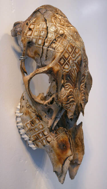 Scrimshaw skull with pattern by artist Adri De La Cruz