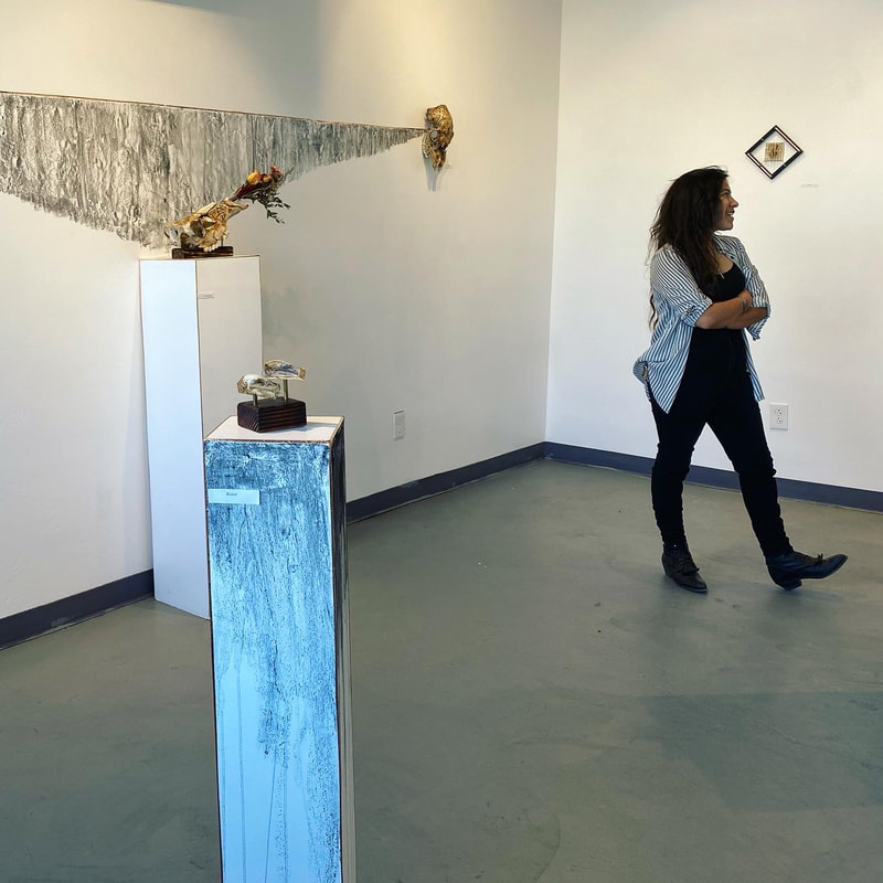 Artist Adri De La Cruz and sculpture work at fourteenfifteen gallery in Albuquerque, NM